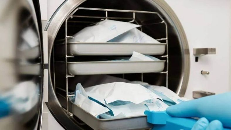 Sterilisation chamber interior with sealed packs on metal trays